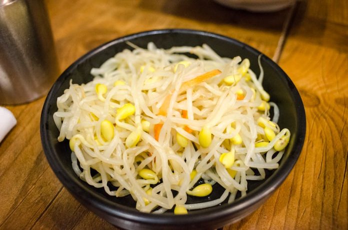 allergen free jang korean sauce trend - Delicious Korean bean sprouts served as a healthy side dish in a black bowl.