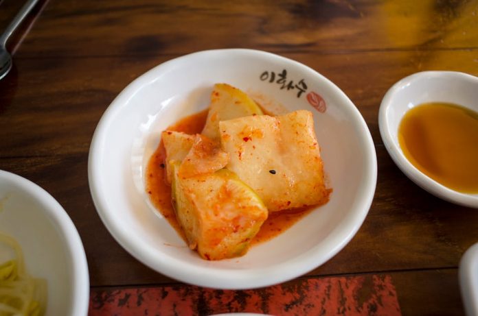 low sodium kimchi korea health trend - Close-up of Korean kkakdugi, diced radish kimchi, served as a side dish.