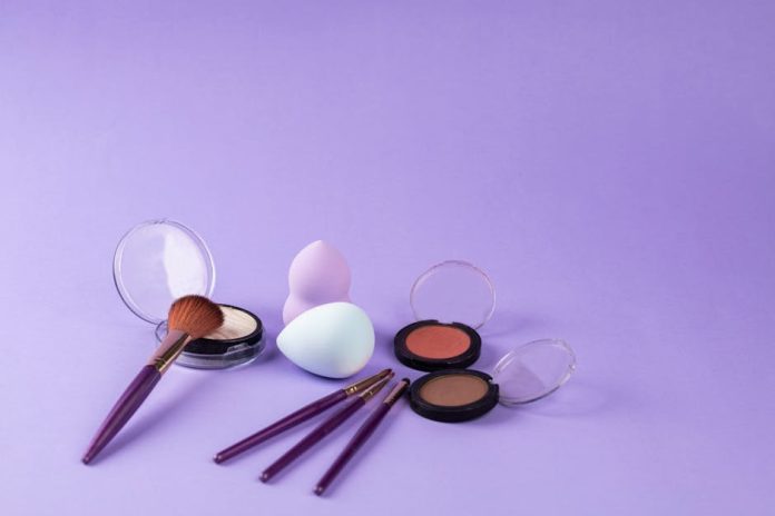 mul-gwang water light Korean makeup trend - A colorful arrangement of makeup products including brushes and beauty sponges on a purple background.